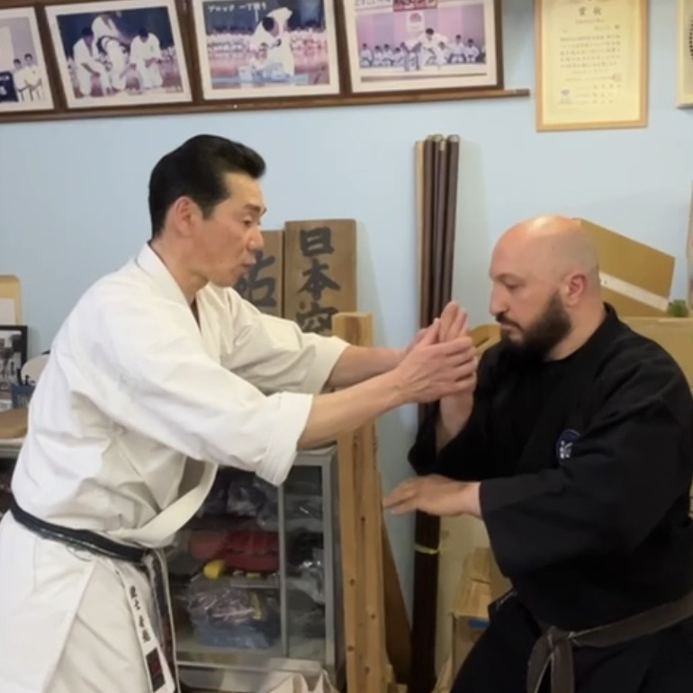 Olgun Tiltay in Ichinomiya Japan doing makiwara training with Funakoshi Masaharu Sensei [8th Dan Karate of Nahate Origin]
